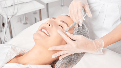 A woman receiving Belotero under-eye treatment in a modern clinic.