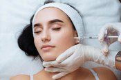 
A professional is administering a Juvederm filler treatment to a relaxed patient, demonstrating the cosmetic procedure aimed at enhancing facial features.