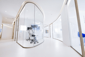 Modern clinic interior with a sleek, white, pod-like treatment room designed for Juvederm lip enhancement procedures, emphasizing a clean and professional atmosphere.
