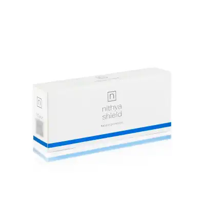 A white rectangular box with the label "NITHYA SHIELD" and the phrase "Natural protection" printed on it. The box features a minimalist design with a small "n" logo at the top and a blue horizontal stripe near the bottom edge of the packaging.