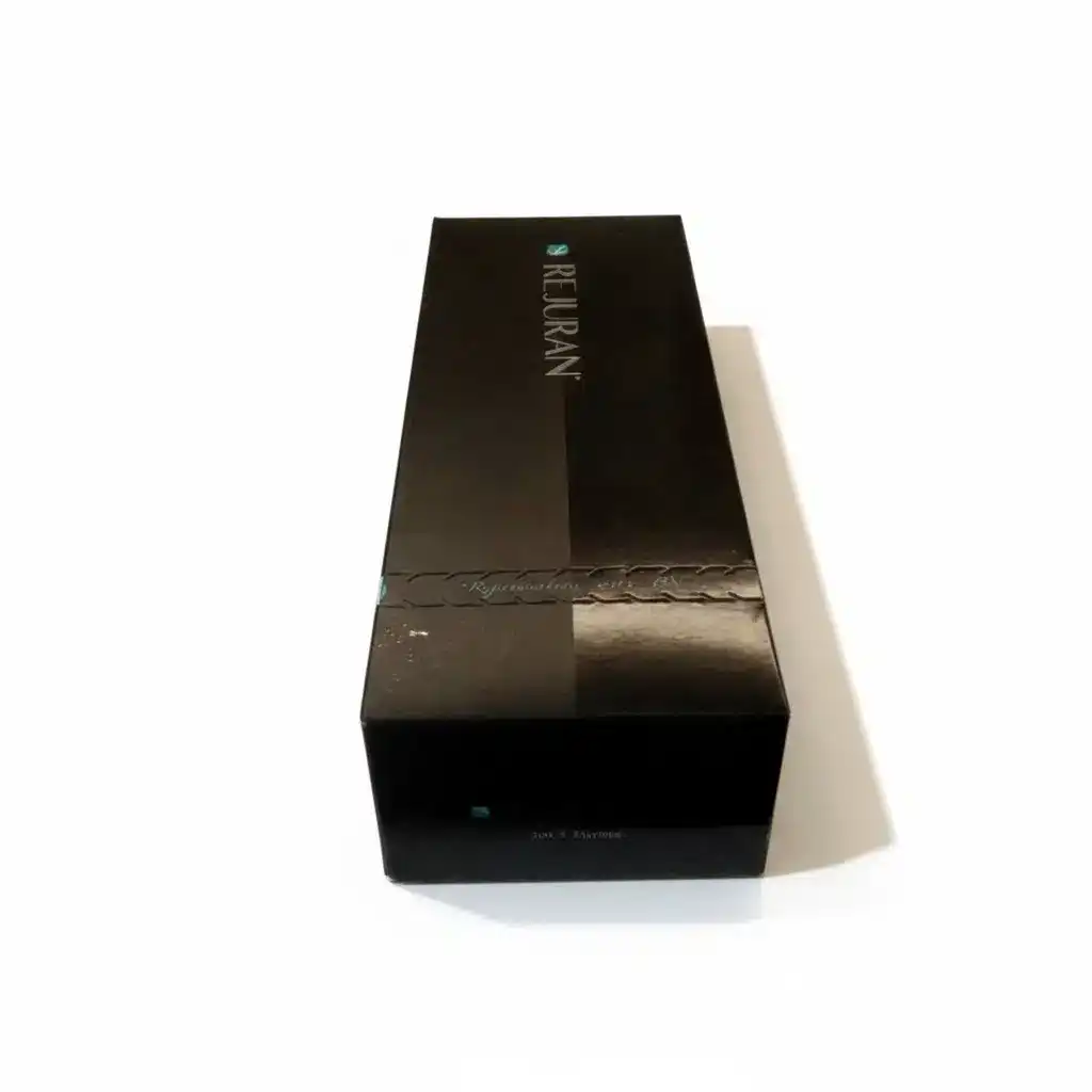 A black rectangular REJURAN® HEALER box sits on a white surface, photographed at an angle highlighting its top and one side.