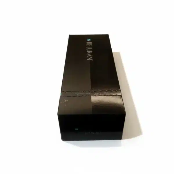A black rectangular REJURAN® HEALER box sits on a white surface, photographed at an angle highlighting its top and one side.