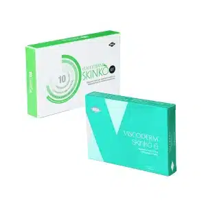 Two upright, overlapping green and white boxes labeled VISCODERM® SKINKÒ E + VISCODERM® SKINKÒ KIT feature modern, clean designs with visible product information on the packaging.
