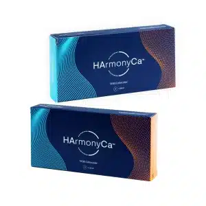 Two rectangular boxes of HArmonyCA™ with Lidocaine, featuring a white and teal design on one box, and a white and orange design on the other. The boxes have a modern look with wavy lines and dot patterns.