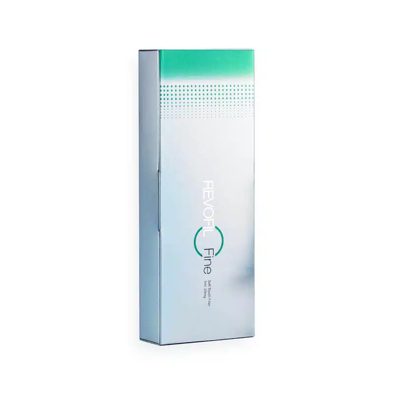 A slender, rectangular, silver-toned product box stands upright. The top of the box features a turquoise gradient with a dotted pattern. The front displays the text "REVOFIL FINE" in modern typography, along with additional small text below it.