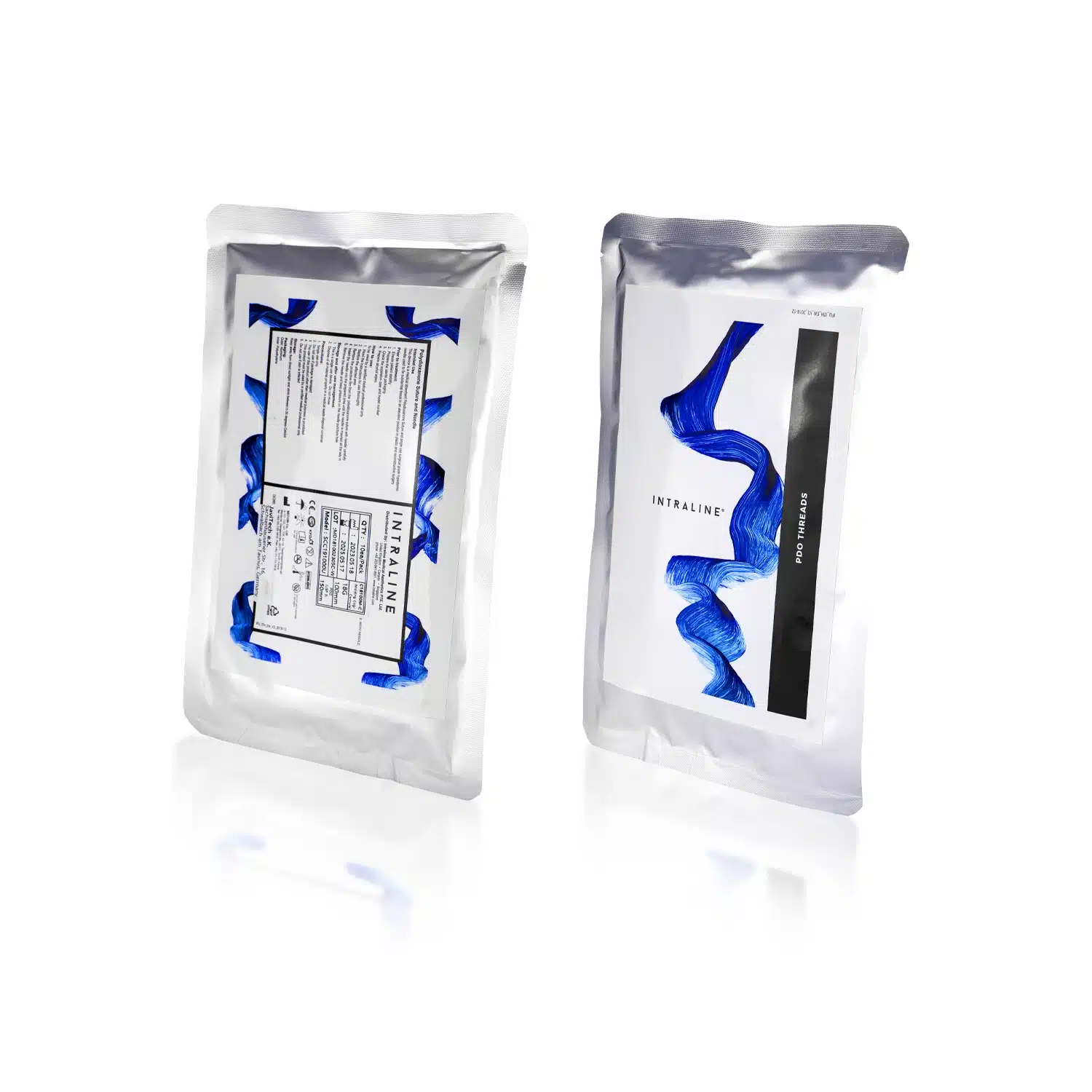 Two silver, foil-like, sterilized pouches stand upright. The front pouch displays the brand