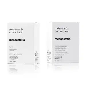 Two white boxes of MESOESTETIC® MELAN TRAN3X CONCENTRATE, a pigment control skincare product, are shown against a white background. The front of the boxes displays the product name, brand logo, and a brief description in black text. The boxes are 30 mL each.