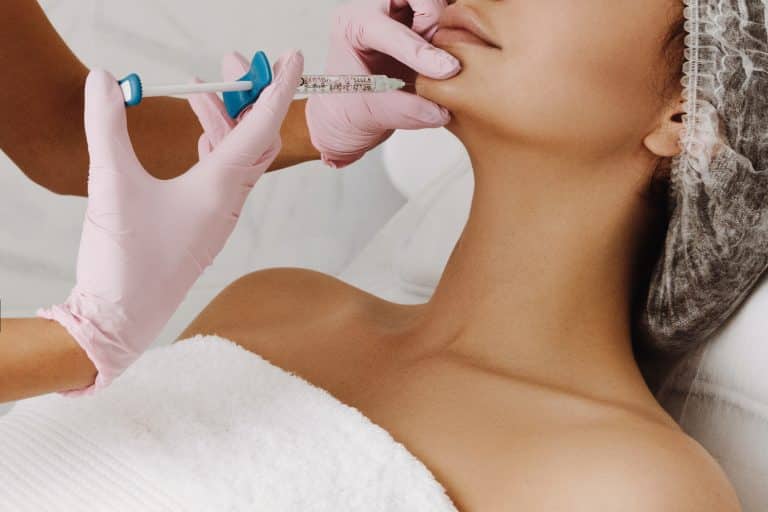 administering cleft chin filler injections