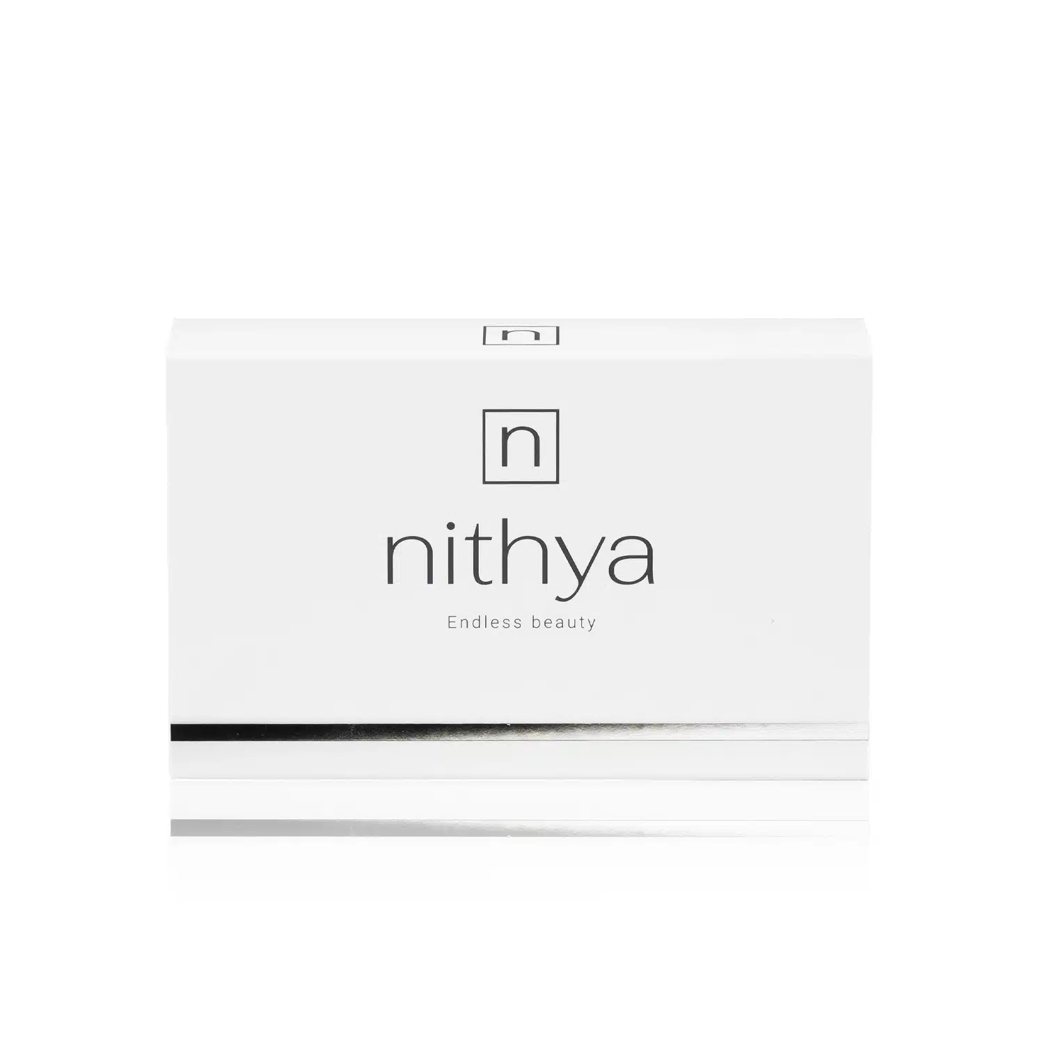 A white rectangular box with "NITHYA ENDLESS BEAUTY" written in lowercase letters in the center and "Endless beauty" beneath it. There is a black and silver horizontal line near the bottom. The top-center has a square logo with a stylized "n" inside. The background is white.