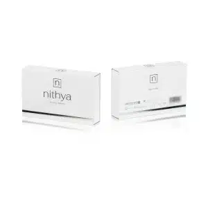 Two white rectangular boxes of NITHYA ENDLESS BEAUTY, a beauty product, are shown. The front of one box displays the brand name and tagline "Endless beauty," while the back of the other box shows detailed product information and a barcode. Both have a minimalist design.