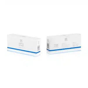 The image shows two white rectangular NITHYA SHIELD boxes standing upright on a reflective surface. Both boxes feature minimalistic designs, with one side displaying the brand name and logo, and the other side showing additional product details.