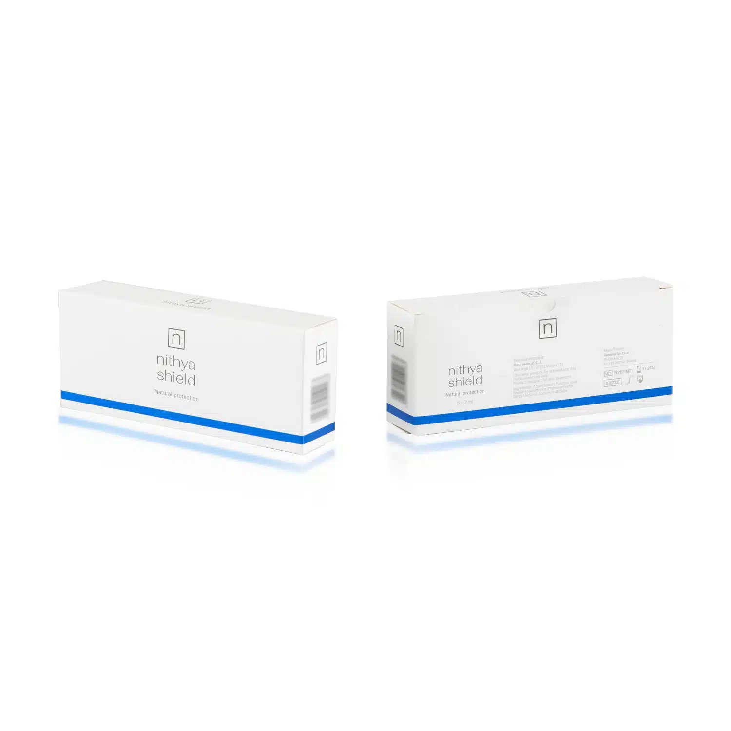 The image shows two white rectangular NITHYA SHIELD boxes standing upright on a reflective surface