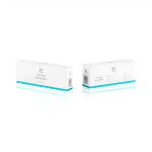 Image of two white and teal rectangular boxes of "NITHYA STIMULATE." The front box displays the product name and some minimal text, while the back box shows additional text and illustrations, likely product information and instructions.