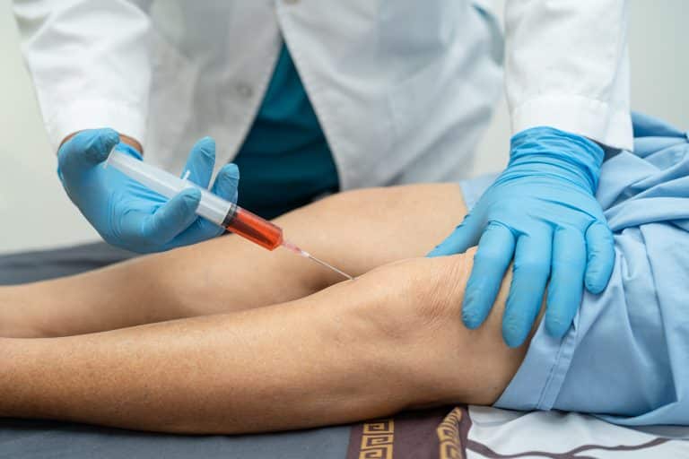 Doctor injecting Orthovisc to the knee