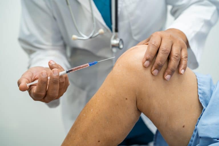 Doctor injecting Orthovisc to the knee