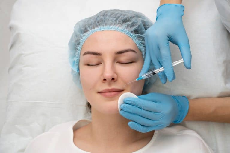 smiling while being injected