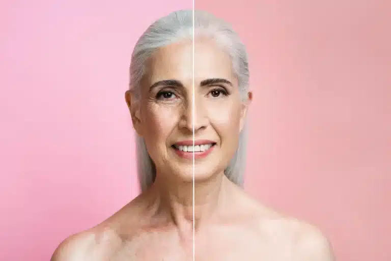 A side-by-side portrait of an older woman with long gray hair, showing a digital enhancement on one half of her face. The left side shows natural skin texture, while the right side appears smoother and more youthful. The background is pink.