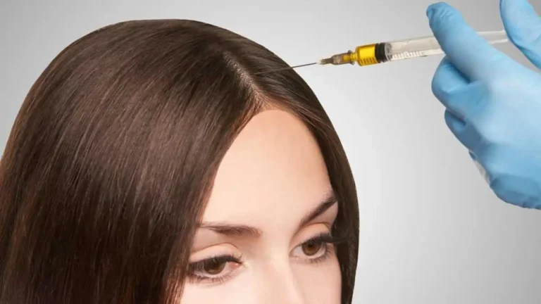 A close-up image of a person with long brown hair receiving an injection in the scalp. A hand in a blue glove holds a syringe, preparing to administer the treatment.