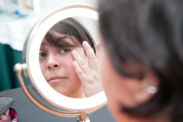 Woman looking into the mirror.