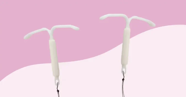 Two white intrauterine devices (IUDs) with T-shaped tops and attached strings are shown against a pink and light pink background.