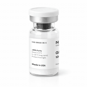 A clear glass vial labeled “GHK-Cu 100mg” features a white label displaying text, a barcode, and a metal cap. The label includes information on purity, storage instructions, CAS number, and “Made in USA.”.