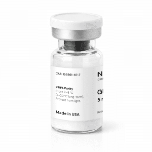 A clear glass vial with a white label and silver cap containing a white powder labeled “GHRP-2 5mg.” The label displays the product’s purity, storage instructions, and states “Made in USA.”.