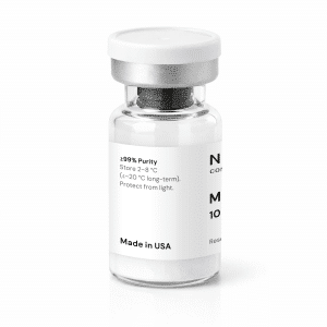 A clear glass vial with a silver cap and a white label displaying “MOTs-C 10mg,” “≥99% Purity,” storage instructions, and “Made in USA.” The vial contains a white powder and is set against a white background.