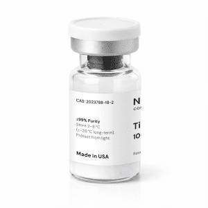 A clear glass vial with a white label showing text including “99% Purity,” storage instructions, and “Made in USA.” The vial has a silver cap and contains a white powdery substance.