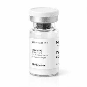 A clear glass vial with a white label and silver cap, containing white powder. The label lists details such as purity, storage instructions, and “Made in USA.” The product or drug name is partially out of view.